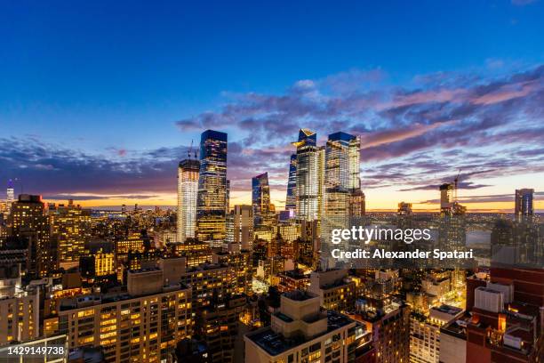 hudson yards skyscrapers illuminated at sunset, new york city, usa - hudson yards stock pictures, royalty-free photos & images
