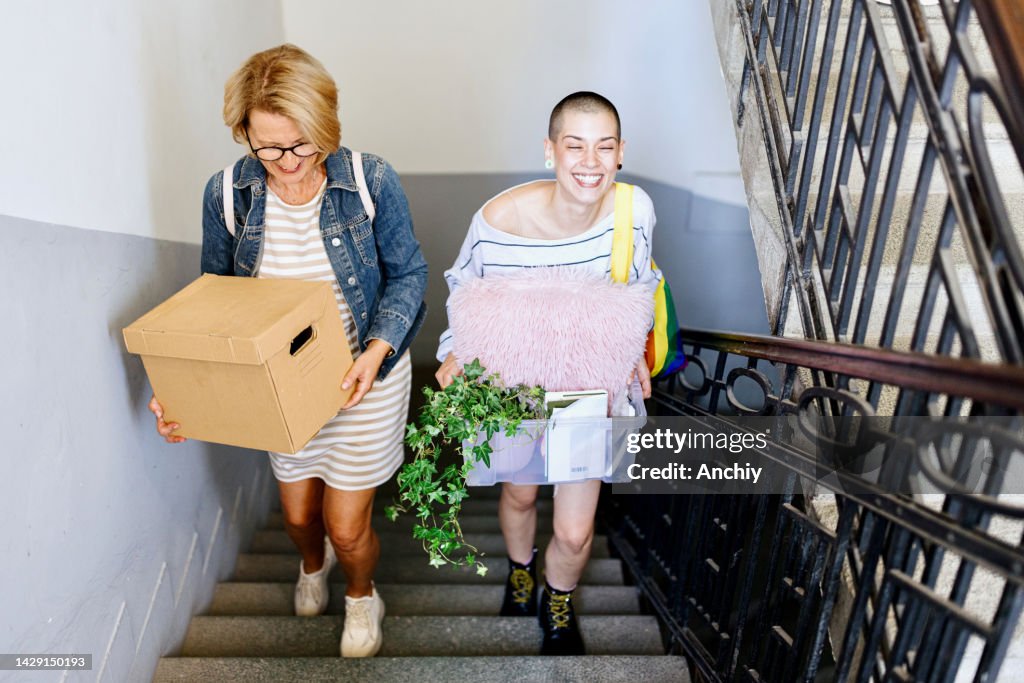 Young woman with mother, moving into apartment