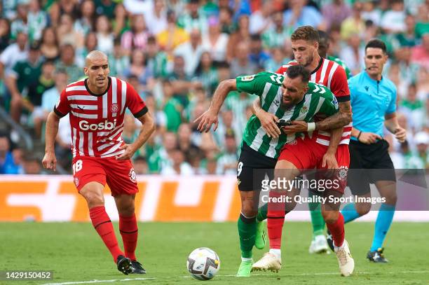 Borja Iglesias of Real Betis competes for the ball with Santiago Bueno of Girona FC during the LaLiga Santander match between Real Betis and Girona...