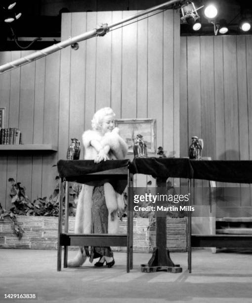 American comedienne, actress, singer and businesswoman, Edie Adams , dressed as Marilyn Monroe, performs a skit at the Tropicana Hotel in Las Vegas,...