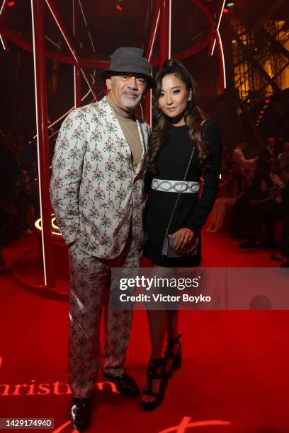 Christian Louboutin and Ashley Park attend The Loubi Show II At Eiffel Tower During Paris Fashion Week, on September 30, 2022 in Paris, France.