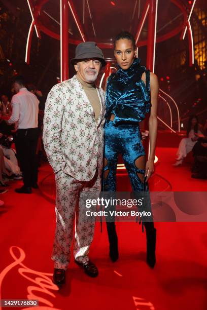 Christian Louboutin and Cindy Bruna attend The Loubi Show II At Eiffel Tower During Paris Fashion Week, on September 30, 2022 in Paris, France.