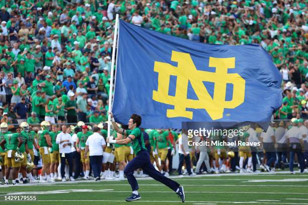 Notre Dame Fighting Irish cheerleader carries a flag against the California Golden Bears during the second half at Notre Dame Stadium on September...