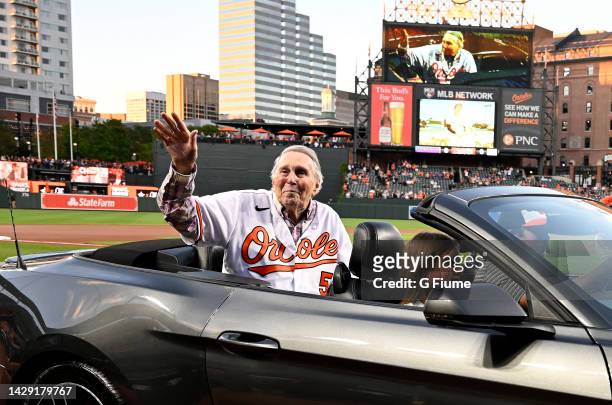 Former Baltimore Orioles and Hall of Famer Brooks Robinson waves to the crowd before the game between the Baltimore Orioles and the Houston Astros at...