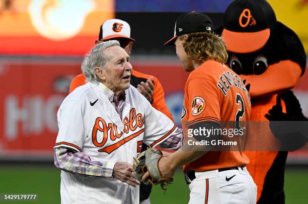 Former Baltimore Orioles and Hall of Famer Brooks Robinson talks with Gunnar Henderson of the Baltimore Orioles before the game between the Baltimore...