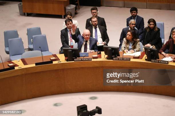 Russian Ambassador to the United Nations Vasily Nebenzya raises a lone hand to vote against a United Nations Security Council resolution to not...
