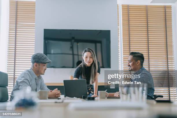 asian chinese woman leading confidently in conference room meeting with her colleague business planning discussion - disability awareness stock pictures, royalty-free photos & images