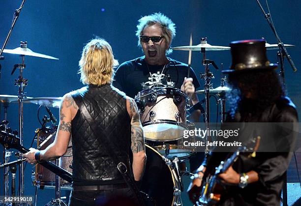 Inductees Duff McKagan, Matt Sorum and Slash of Guns N' Roses perform on stage at the 27th Annual Rock And Roll Hall Of Fame Induction Ceremony at...