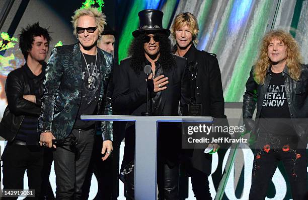 Inductee Slash of Guns N' Roses speaks as fellow inductees Matt Sorum, Duff McKagan and Steven Adler look on at the 27th Annual Rock And Roll Hall Of...