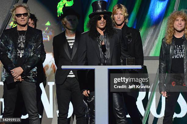 Inductee Slash of Guns N' Roses speaks as fellow inductees Matt Sorum, Duff McKagan and Steven Adler look on at the 27th Annual Rock And Roll Hall Of...