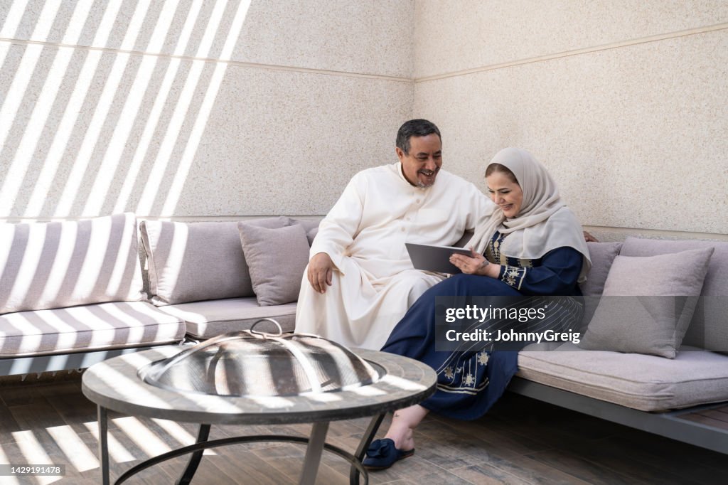 Saudi couple enjoying weekend leisure with technology