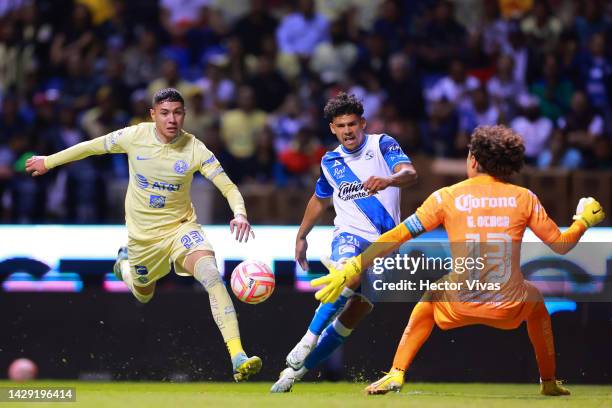 Maximiliano Araujo of Puebla battles for possession with Emilio Lara and Guillermo Ochoa of America during the 17th round match between Puebla and...