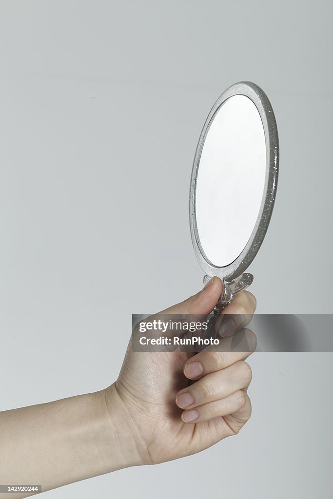 Young woman with mirror