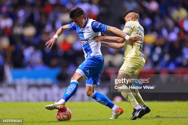 Pablo Parra of Puebla battles for possession with Jonathan Dos Santos of America during the 17th round match between Puebla and America as part of...