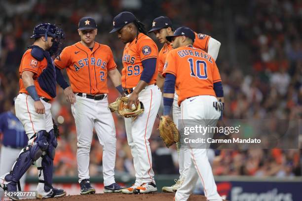 Yuli Gurriel, Christian Vazquez, and Alex Bregman of the Houston Astros visit Framber Valdez during the sixth inning against the Tampa Bay Rays at...