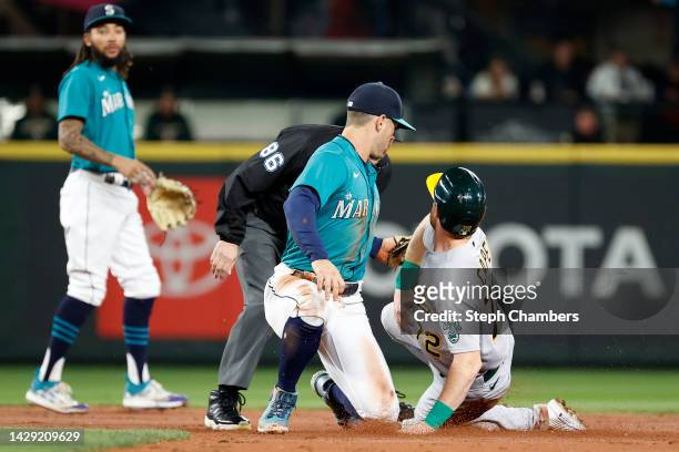 Dylan Moore of the Seattle Mariners tags out Conner Capel of the Oakland Athletics during the second inning at T-Mobile Park on September 30, 2022 in...