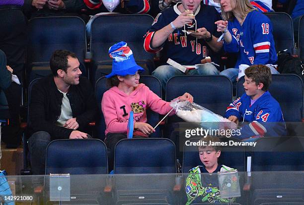 Jude Law, Iris Law and Rudy Law attend the Ottawa Senators vs New York Rangers game at Madison Square Garden on April 14, 2012 in New York City.