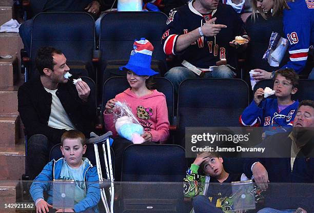 Jude Law, Iris Law and Rudy Law attend the Ottawa Senators vs New York Rangers game at Madison Square Garden on April 14, 2012 in New York City.