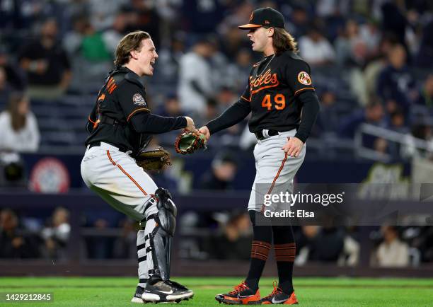 Adley Rutschman and DL Hall of the Baltimore Orioles celebrate the win over the New York Yankees at Yankee Stadium on September 30, 2022 in the Bronx...