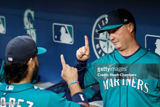 Eugenio Suarez and manager Scott Servais of the Seattle Mariners react before the game against the Oakland Athletics at T-Mobile Park on September...
