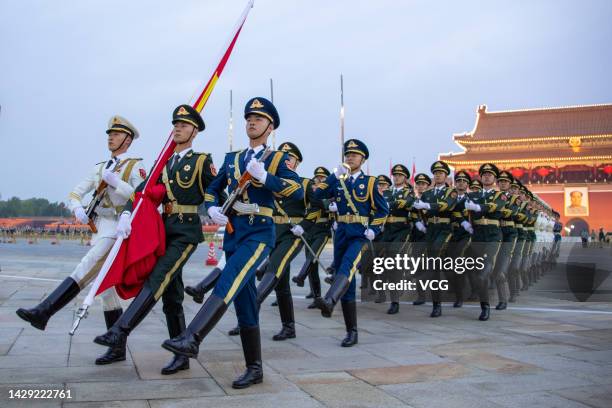 The Guard of Honor of the Chinese People's Liberation Army escorts the Chinese national flag during a flag-raising ceremony in celebration of the...