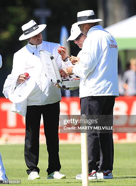 Umpirers Aleem Dar and BR Doctrove check the new match ball during day two of the first five day international cricket test match between New Zealand...