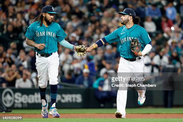 Crawford and Eugenio Suarez of the Seattle Mariners fist bump during the fourth inning against the Oakland Athletics at T-Mobile Park on September...