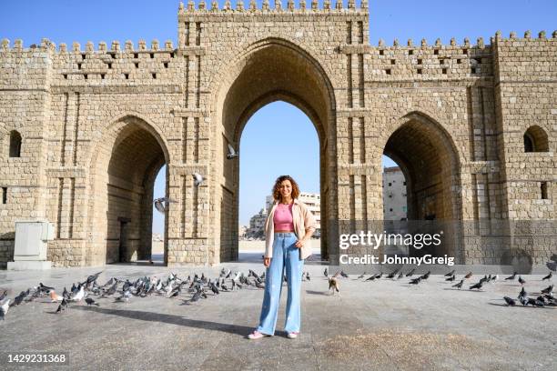 local young woman standing in front of baab makkah jeddah - saudi arabia national day stock pictures, royalty-free photos & images