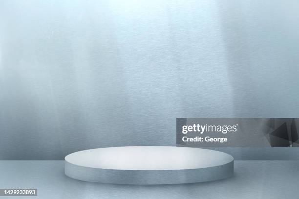 silver cylindrical podium and silver background. - awards winners room stock pictures, royalty-free photos & images