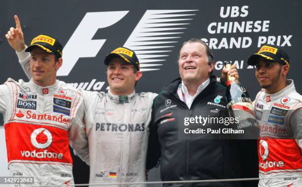 Race winner Nico Rosberg of Germany and Mercedes GP celebrates with second placed Jenson Button of Great Britain and McLaren, third placed Lewis...