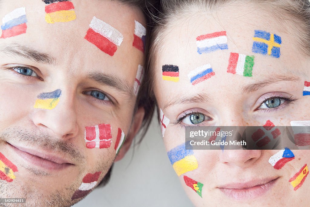 Smiling couple with flag paintings