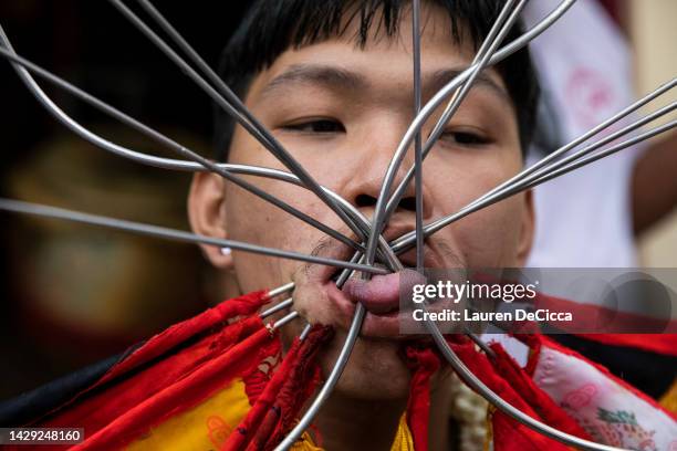 Thai devotees pierced with long needles during a ritual at the Bang Neow Shrine on October 1, 2022 in Phuket, Thailand. The annual Vegetarian...