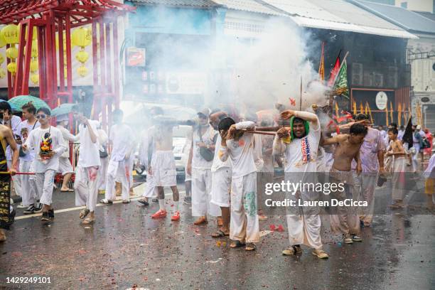 Thai devotees set off fire crackers during the Vegetarian Festival street procession on October 1, 2022 in Phuket, Thailand. The annual Vegetarian...