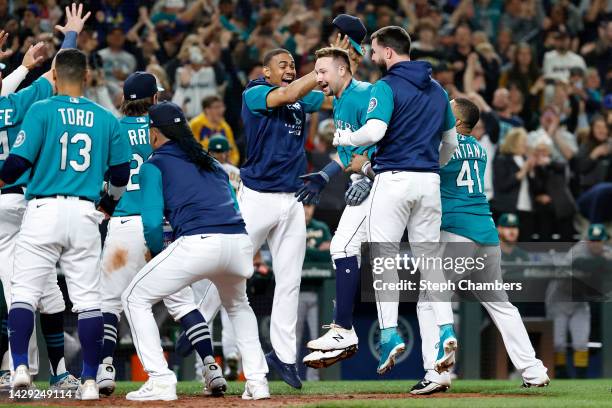 Cal Raleigh of the Seattle Mariners celebrates his walk-off home run during the ninth inning against the Oakland Athletics at T-Mobile Park on...