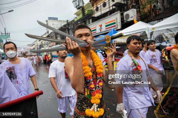 Thai devotees march in a parade from the Bang Neow Shrine to the Saphan Hin park during the Vegetarian Festival on October 1, 2022 in Phuket,...