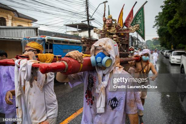 Thai devotees march in a parade from the Bang Neow Shrine to the Saphan Hin park during the Vegetarian Festival on October 1, 2022 in Phuket,...