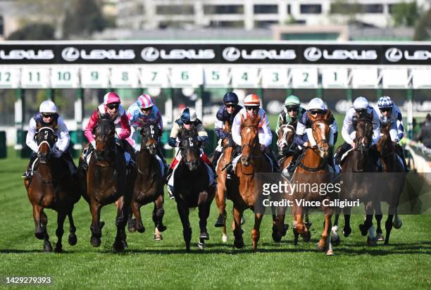 The field race to the first turn in Race 6, the The Lexus Bart Cummings, during Turnbull Stakes Day at Flemington Racecourse on October 01, 2022 in...