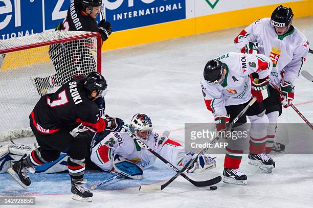 Hungary's goalkeeper Bence Balizs tries to cover the puck during the 2012 IIHF Ice Hockey World Championship Div I Group A match between Japan and...