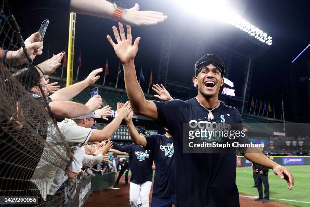 Julio Rodriguez of the Seattle Mariners celebrates with fans after clinching a postseason birth after beating the Oakland Athletics 2-1 at T-Mobile...