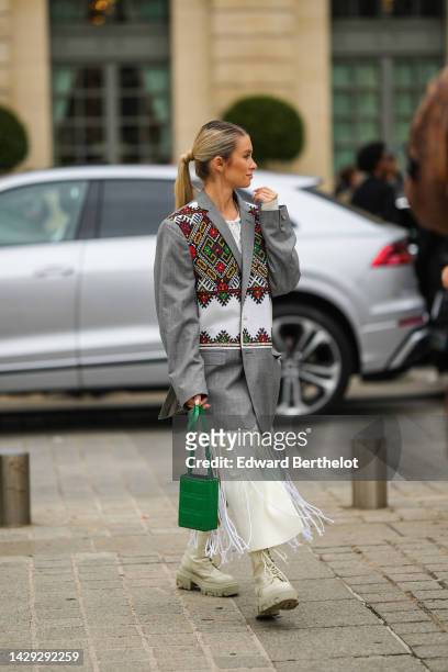 Guest wears a white latte ribbed wool long dress, a white fringed mesh long dress, a gray oversized blazer jacket with white / green / red / orange...