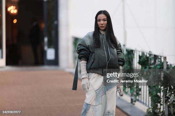 Yoyo Cao seen wearing a long denim patchwork skirt and oversize leather jacket, outside Acne Studios during Paris Fashion Week on September 28, 2022...