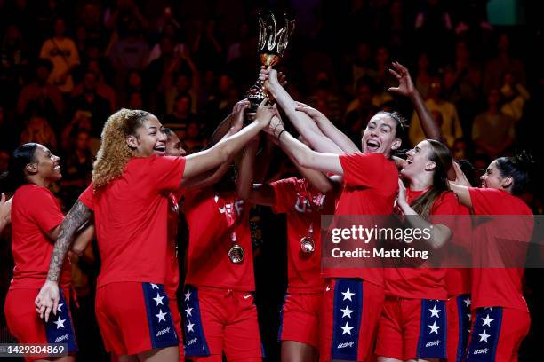 Breanna Stewart of the United States holds the trophy aloft with team mates after the 2022 FIBA Women's Basketball World Cup Final match between USA...