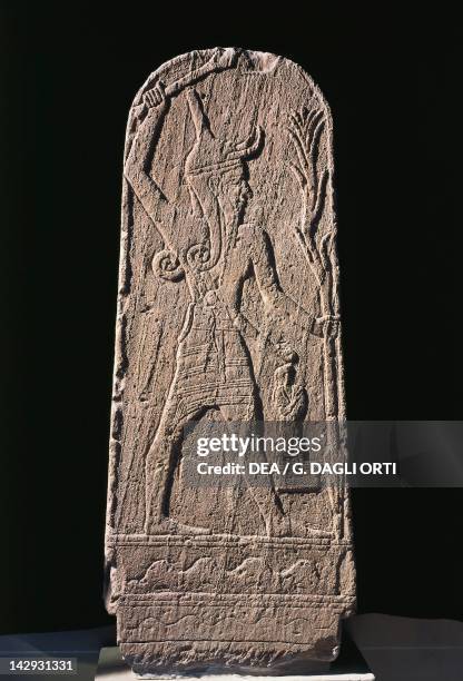Relief representing Baal and lightning, artefact comes from the acropolis of Ugarit, or Ras Shamra, Syria. Assyrian civilisation, 18th Century BC....