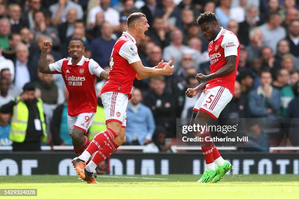 Thomas Partey of Arsenal celebrates with team mate Granit Xhaka after scoring their sides first goal during the Premier League match between Arsenal...