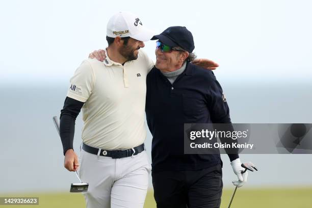 Adrian Otaegui of Spain embraces with Musician Tico Torres on the 4th green on Day Three of the Alfred Dunhill Links Championship at Kingsbarns Golf...