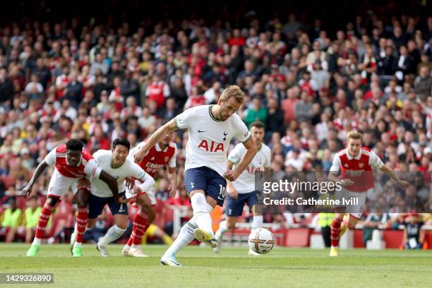 Harry Kane of Tottenham Hotspur scores their sides first goal from the penalty spot during the Premier League match between Arsenal FC and Tottenham...