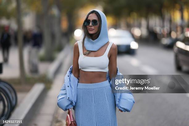 Fashion week guest seen wearing a blue matching look with dark sunglasses, outside Acne Studios during Paris Fashion Week on September 28, 2022 in...