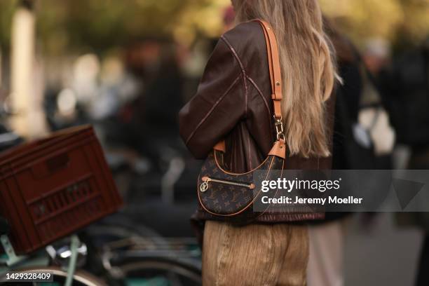 Fashion week guest seen wearing a louis vuitton bag and a dark brown leather jacket, outside Acne Studios during Paris Fashion Week on September 28,...