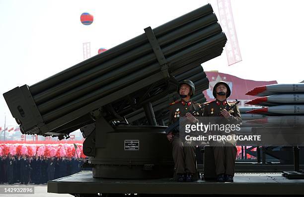 North Korean soldiers ride on the back of a MLRS during a military parade to mark 100 years since the birth of North Korea's founder Kim Il-Sung in...