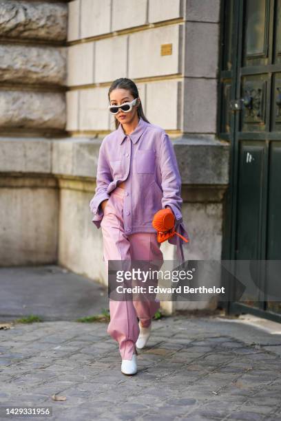 Jenny Tsang in Suet wears white puffy sunglasses from Loewe, silver earrings, a silver large chain necklace, a purple denim shirt from Loewe, pale...